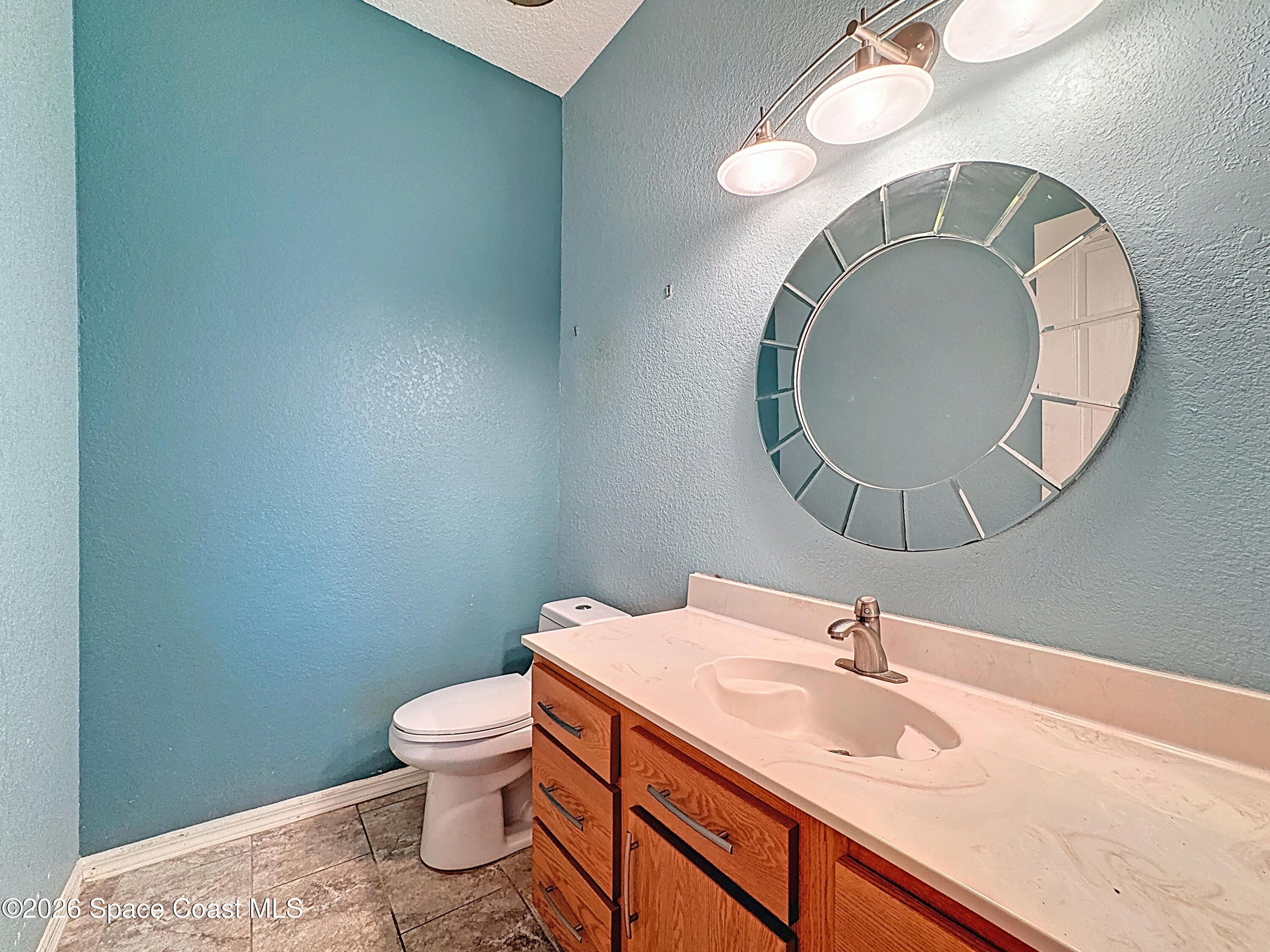 4073 Sand Ridge Drive Merritt Island, FL 32953 - Photo 66 of 66 a bathroom with a sink and a mirror