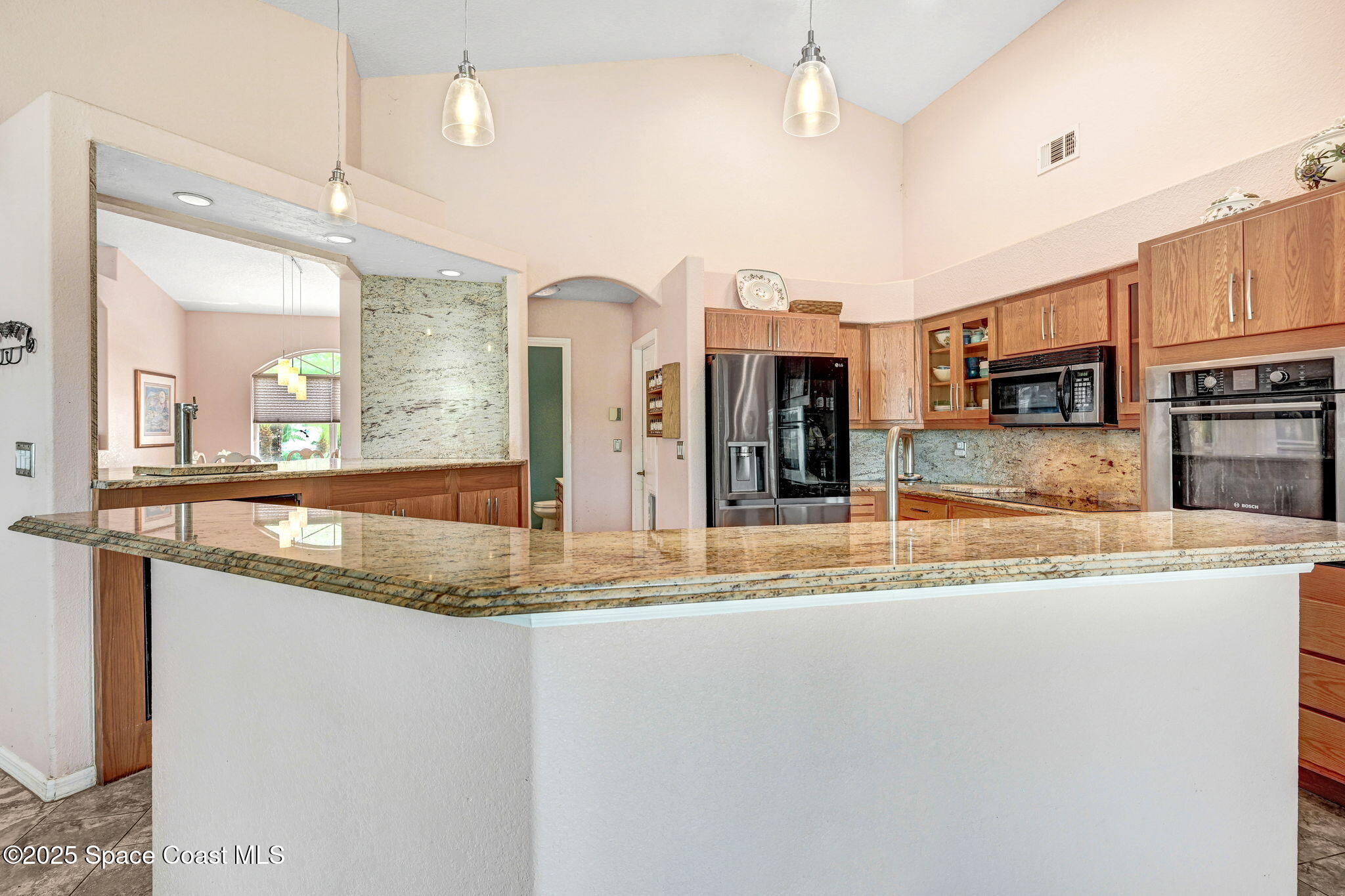 4073 Sand Ridge Drive Merritt Island, FL 32953 - Photo 9 of 66 a view of a kitchen with stainless steel appliances granite countertop a sink and a refrigerator