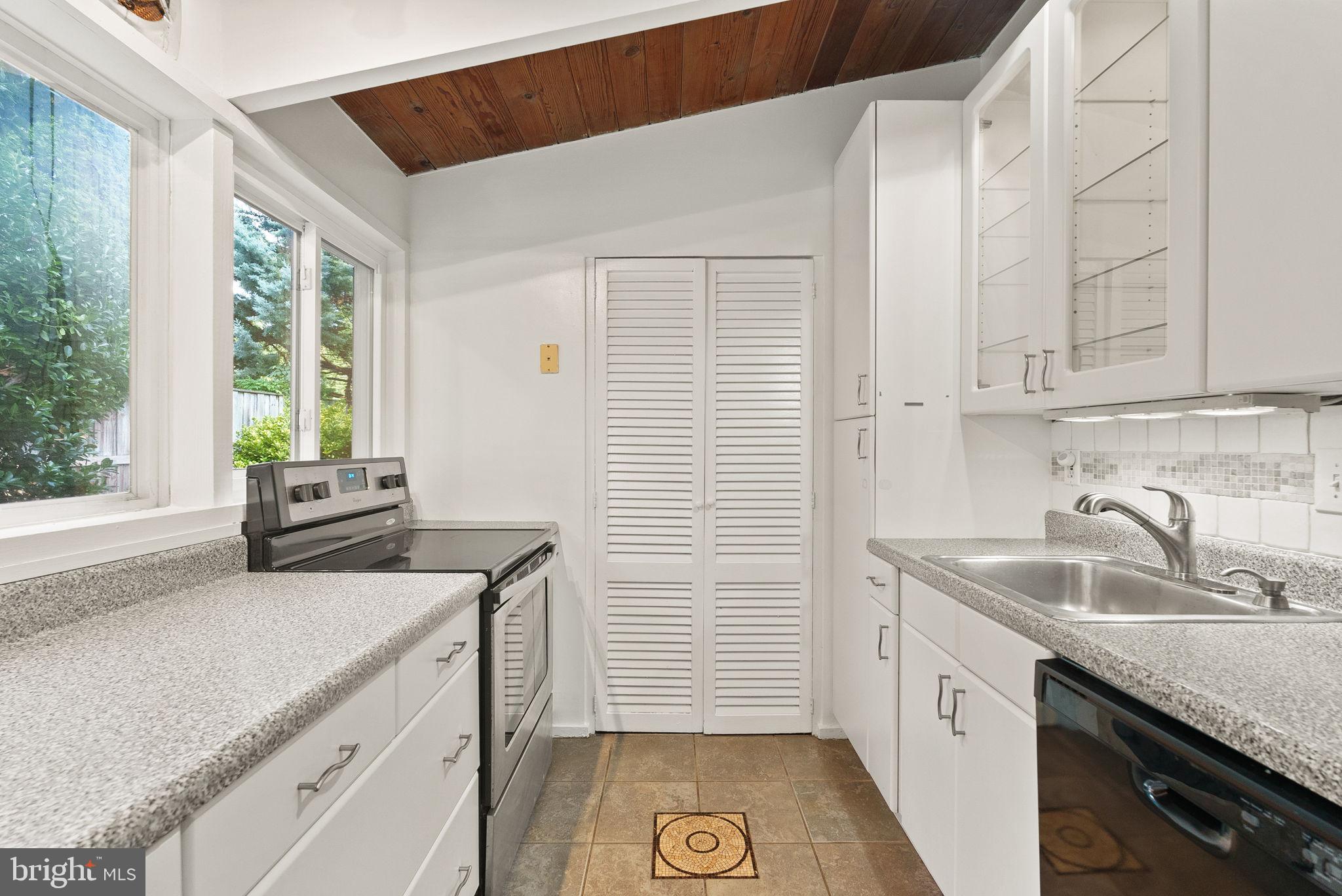 2602 Harris Avenue Silver Spring, MD 20902 - Photo 11 of 25 a kitchen with a sink stove and cabinets