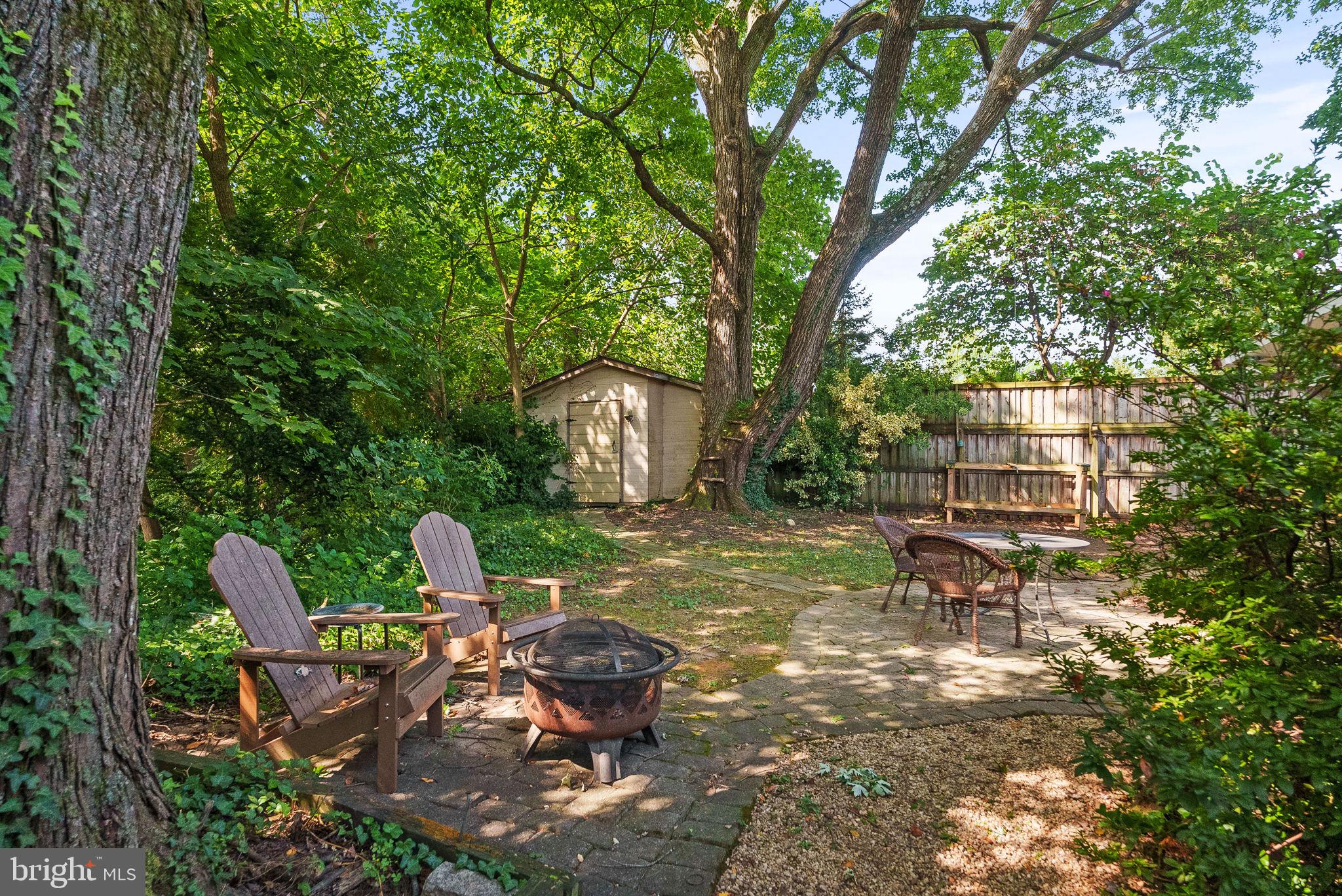 2602 Harris Avenue Silver Spring, MD 20902 - Photo 24 of 25 a view of a backyard with table and chairs and a fire pit
