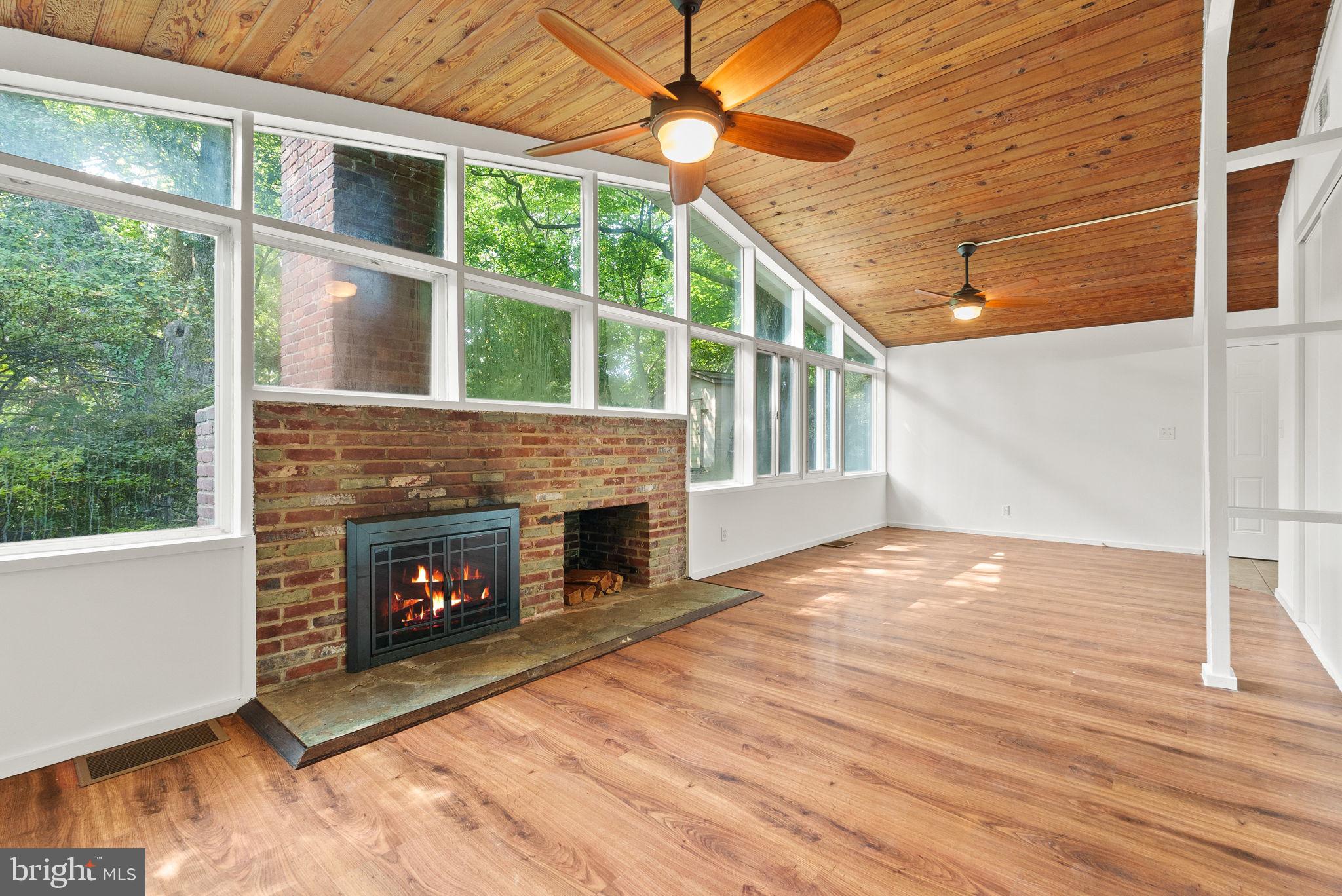 2602 Harris Avenue Silver Spring, MD 20902 - Photo 6 of 25 a view of an empty room with wooden floor fireplace and a window