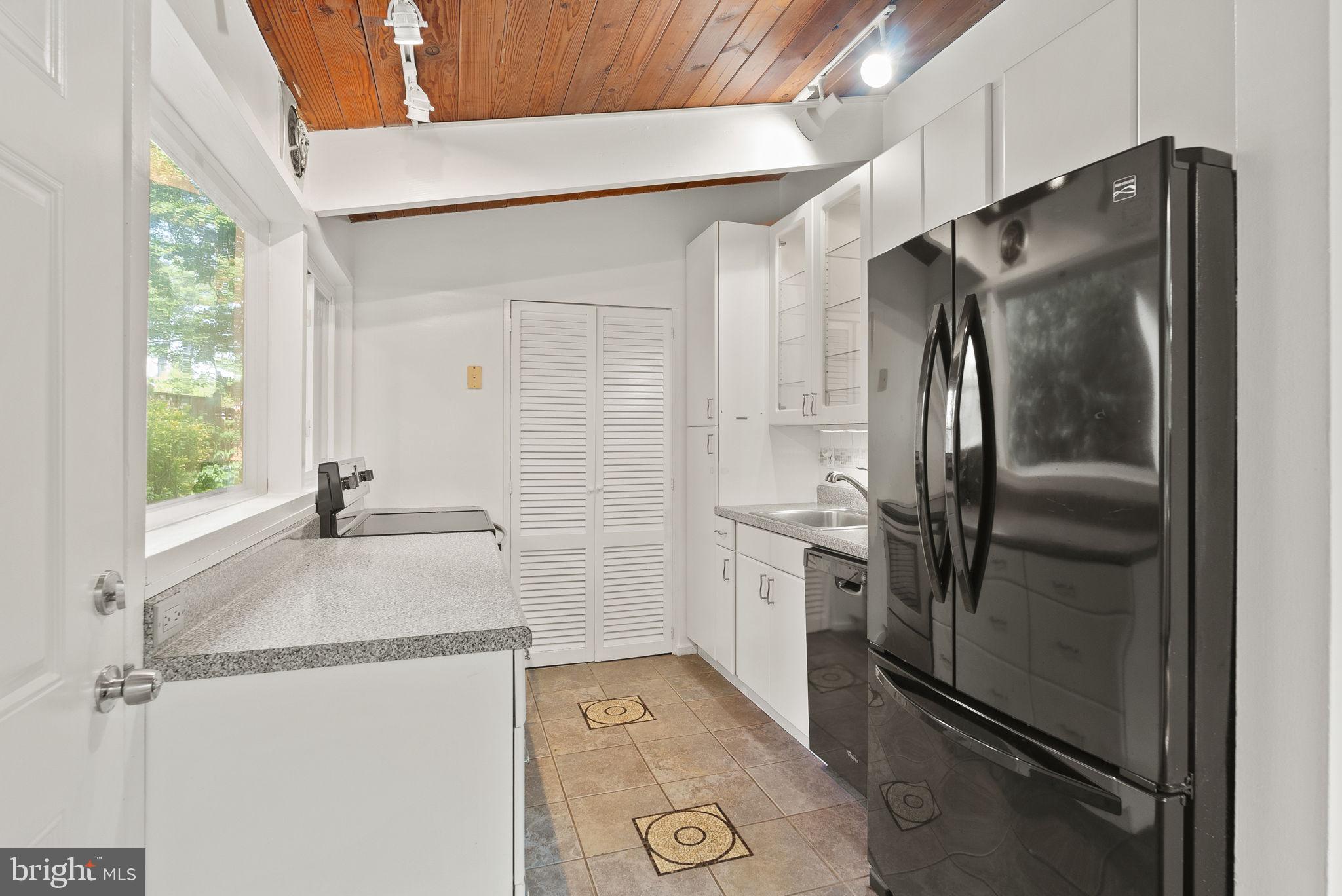 2602 Harris Avenue Silver Spring, MD 20902 - Photo 9 of 25 a kitchen with a refrigerator and a sink