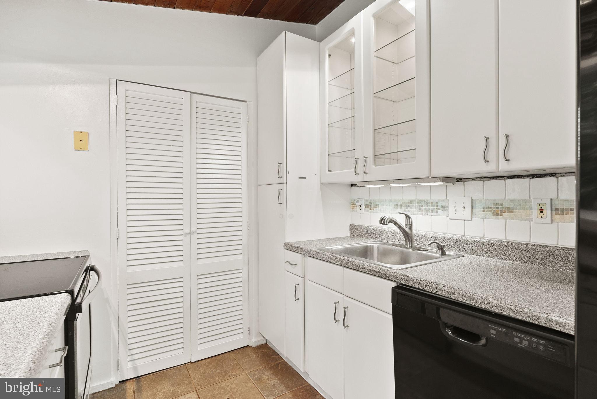 2602 Harris Avenue Silver Spring, MD 20902 - Photo 10 of 25 a kitchen with stainless steel appliances granite countertop white sink and dishwasher