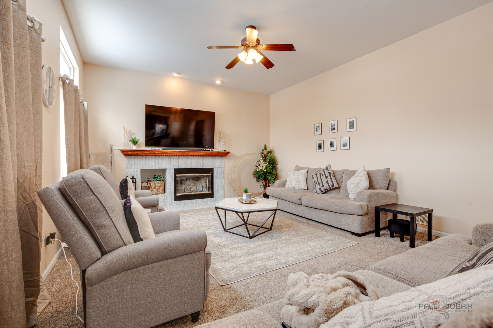 578 North Overlook Trail Round Lake, IL 60073 - Photo 11 of 42 a living room with furniture a flat screen tv and a fireplace