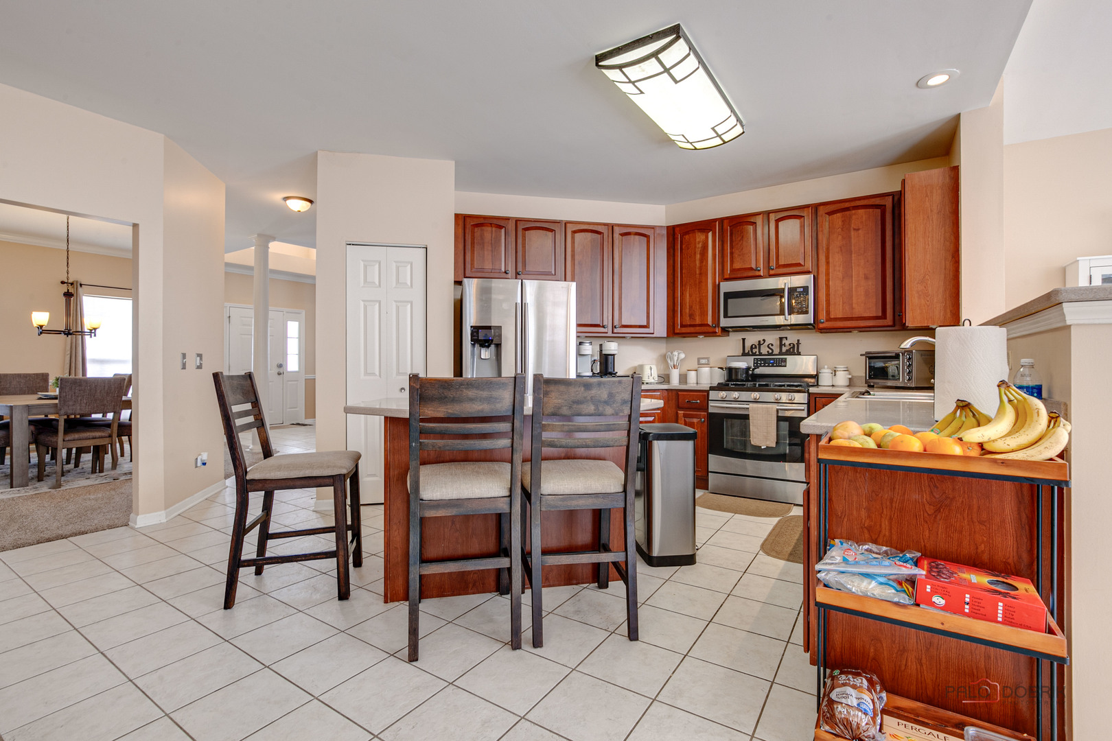 578 North Overlook Trail Round Lake, IL 60073 - Photo 14 of 42 a kitchen with stainless steel appliances kitchen island granite countertop a dining table chairs and a refrigerator