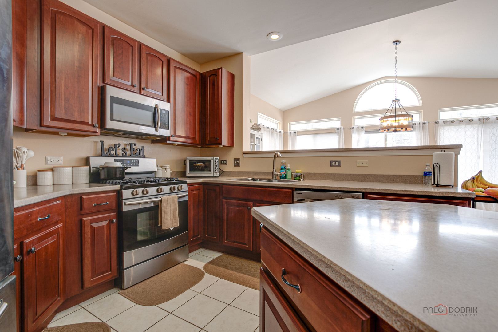 578 North Overlook Trail Round Lake, IL 60073 - Photo 15 of 42 a kitchen with stainless steel appliances granite countertop a sink wooden cabinets and a stove