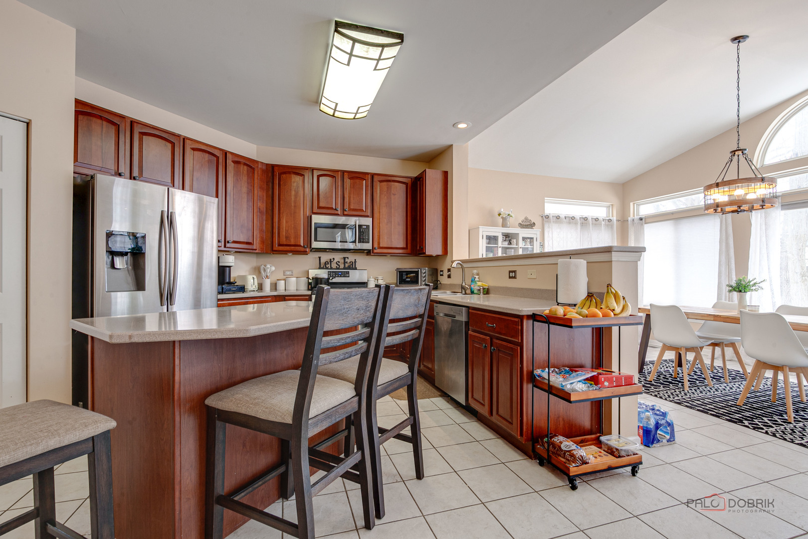 578 North Overlook Trail Round Lake, IL 60073 - Photo 17 of 42 a kitchen with stainless steel appliances a table chairs refrigerator and a sink