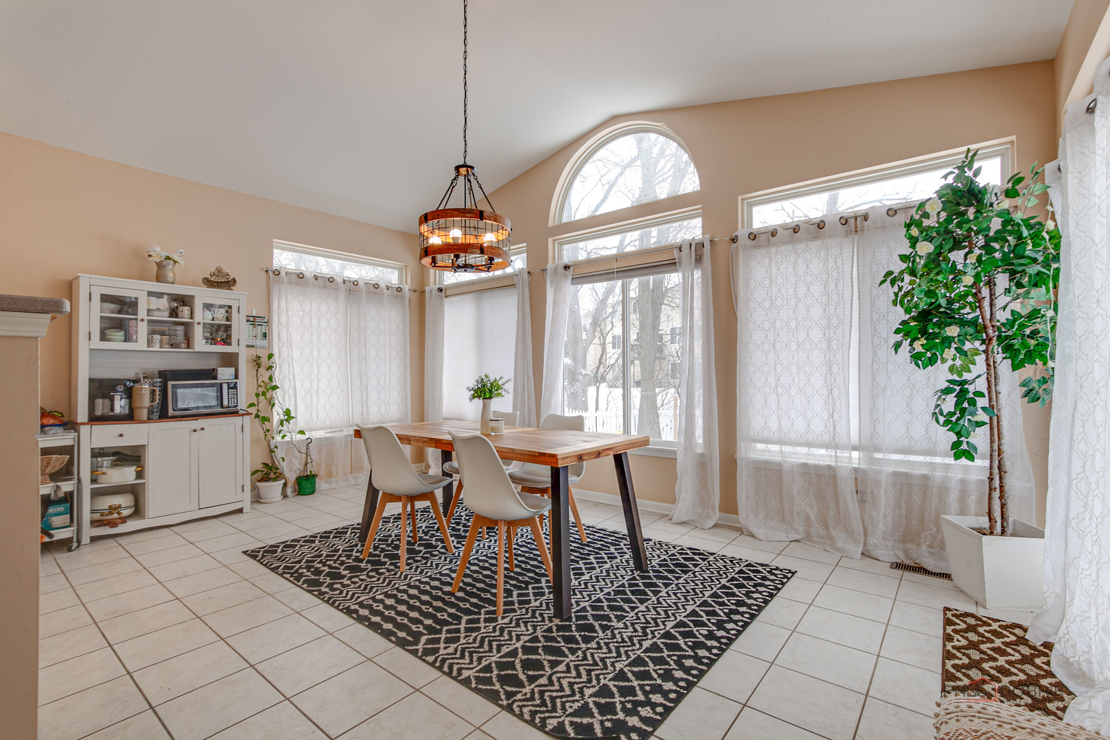 578 North Overlook Trail Round Lake, IL 60073 - Photo 18 of 42 a dining room with wooden floor a chandelier a wooden table and chairs