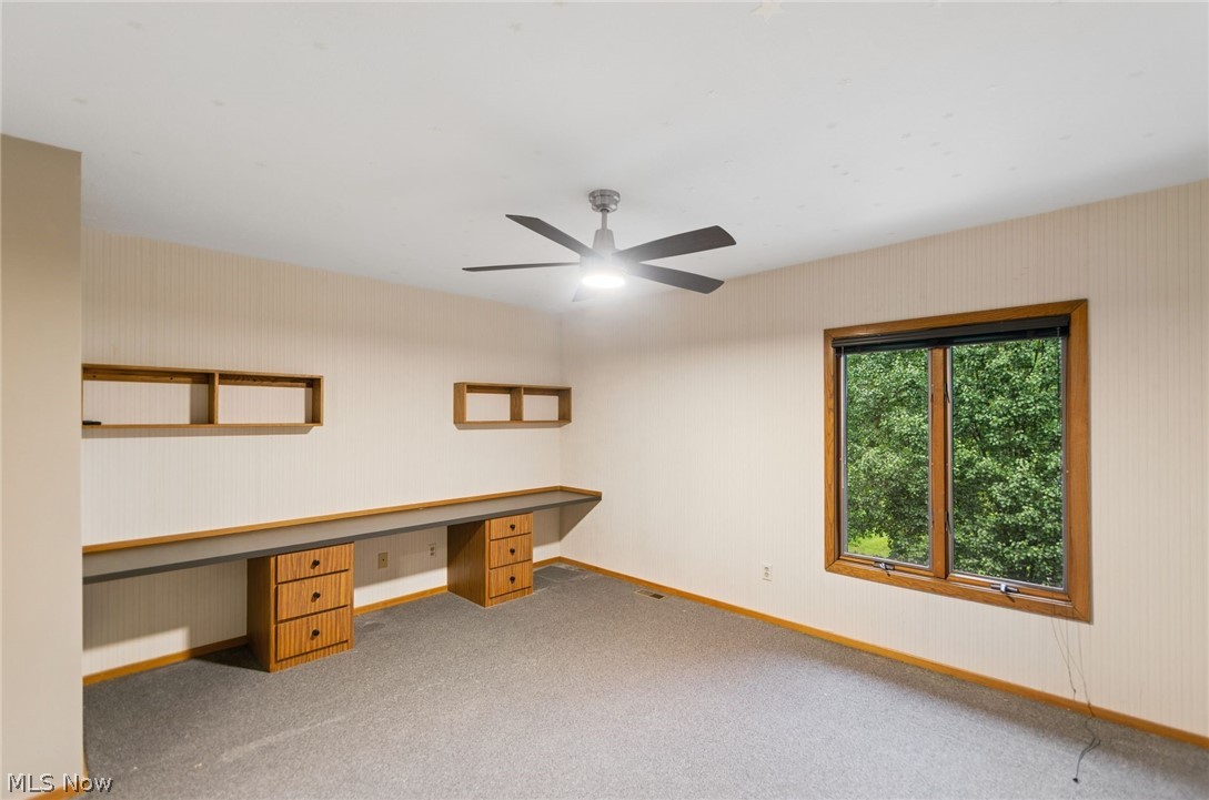200 Hampshire Road Akron, OH 44313 - Photo 35 of 50 Built-in wooden desk with drawers, overhead shelving, large picture window, and ceiling fan