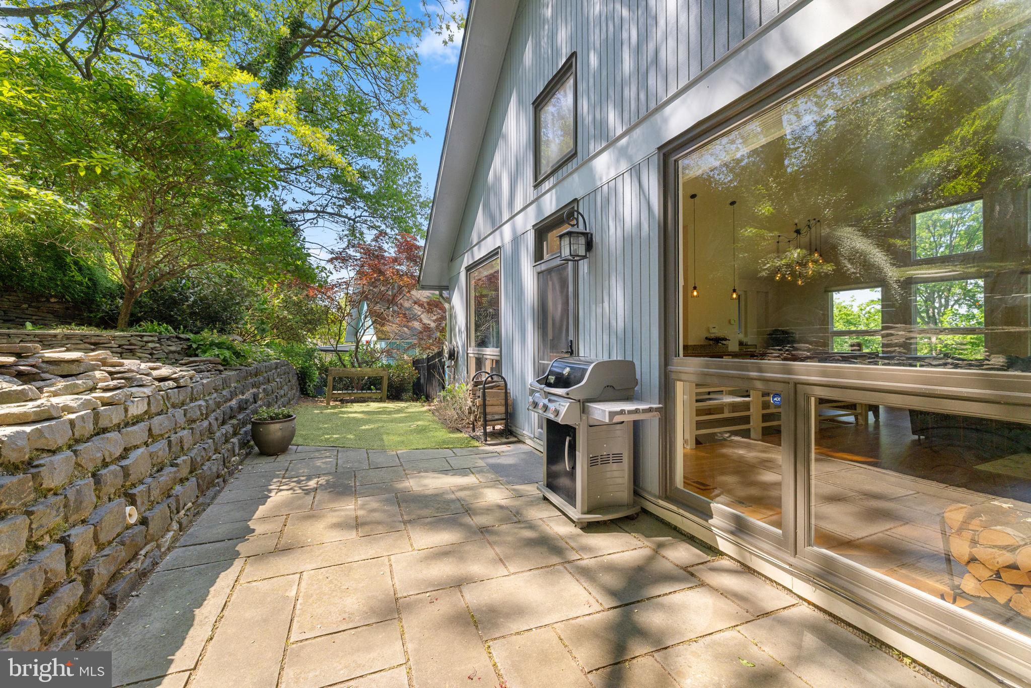 2621 South Arlington Ridge Road Arlington, VA 22202 - Photo 54 of 56 a view of a patio with table and chairs and floor to ceiling window