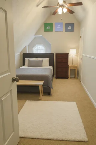a living room with a bed furniture and a chandelier