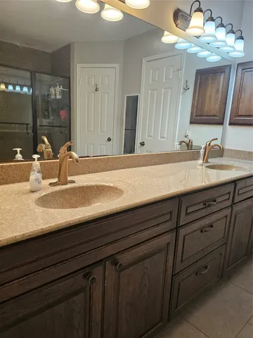 a bathroom with a sink double vanity and a mirror