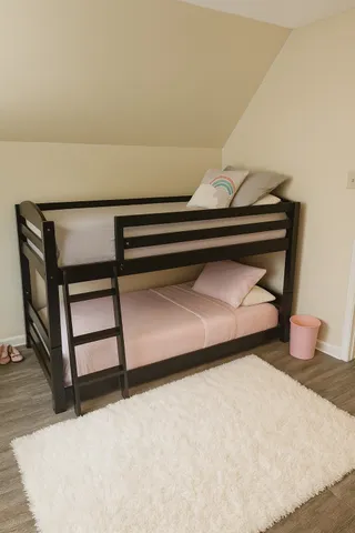 a bedroom with a bed and a night stand