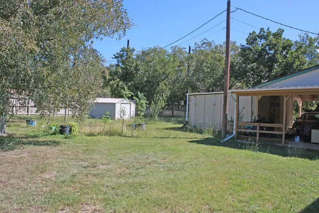 a backyard of a house with table and chairs