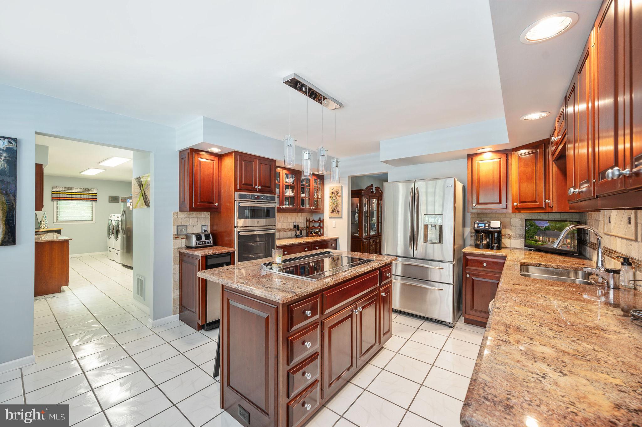 11105 Waddell Road Bumpass, VA 23024 - Photo 23 of 76 a kitchen with stainless steel appliances granite countertop a stove refrigerator and a sink