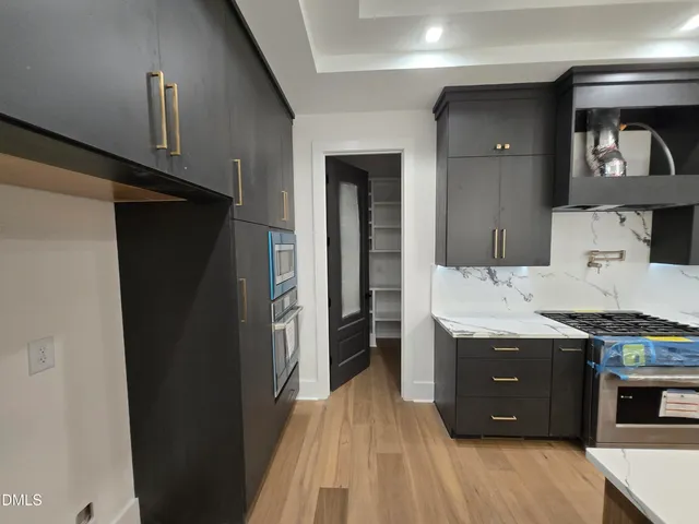 a view of kitchen with a refrigerator and a stove