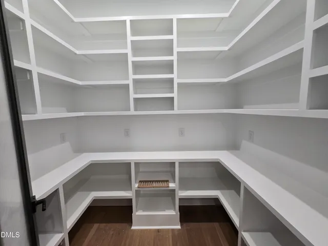 a view of walk in closet with empty racks