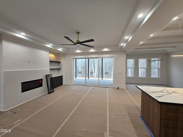 a large space with chandelier and couches