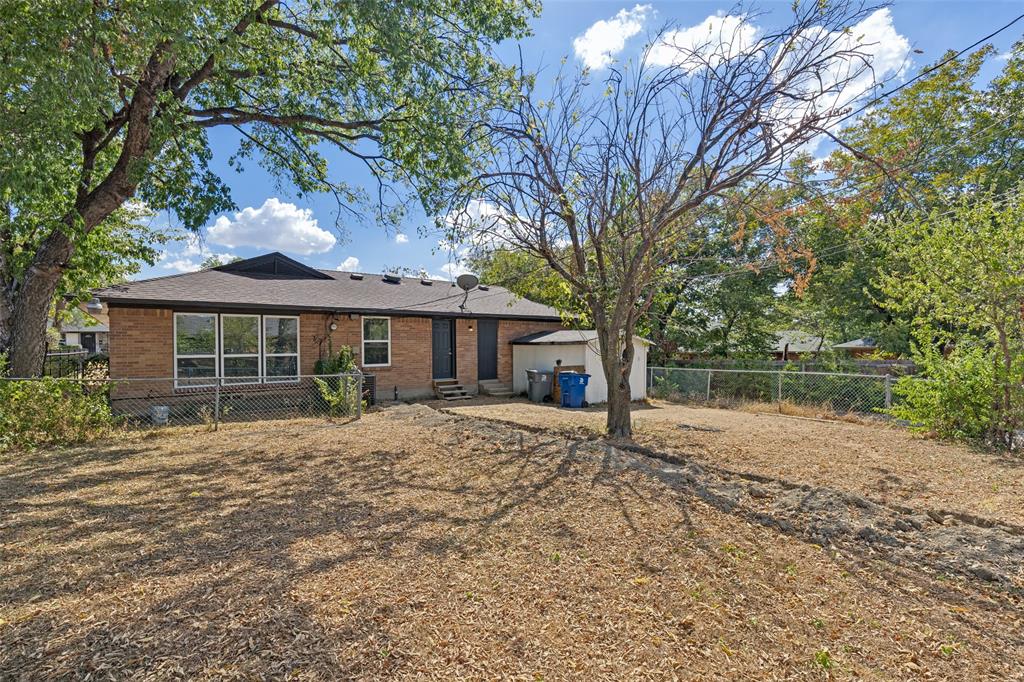 1215 Fordham Road Dallas, TX 75216 - Photo 25 of 25 Brick exterior with multiple windows and a dark shingle roof