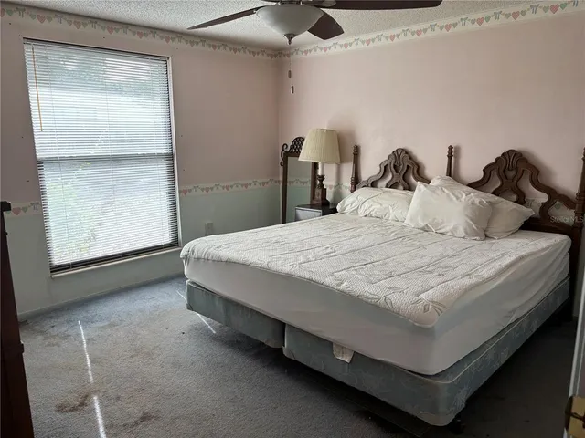 a bed sitting in a bedroom next to a window