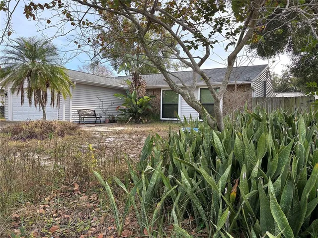 a view of a house with a tree in a yard