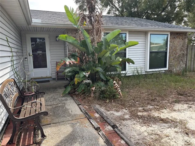 a view of a house with backyard and sitting area