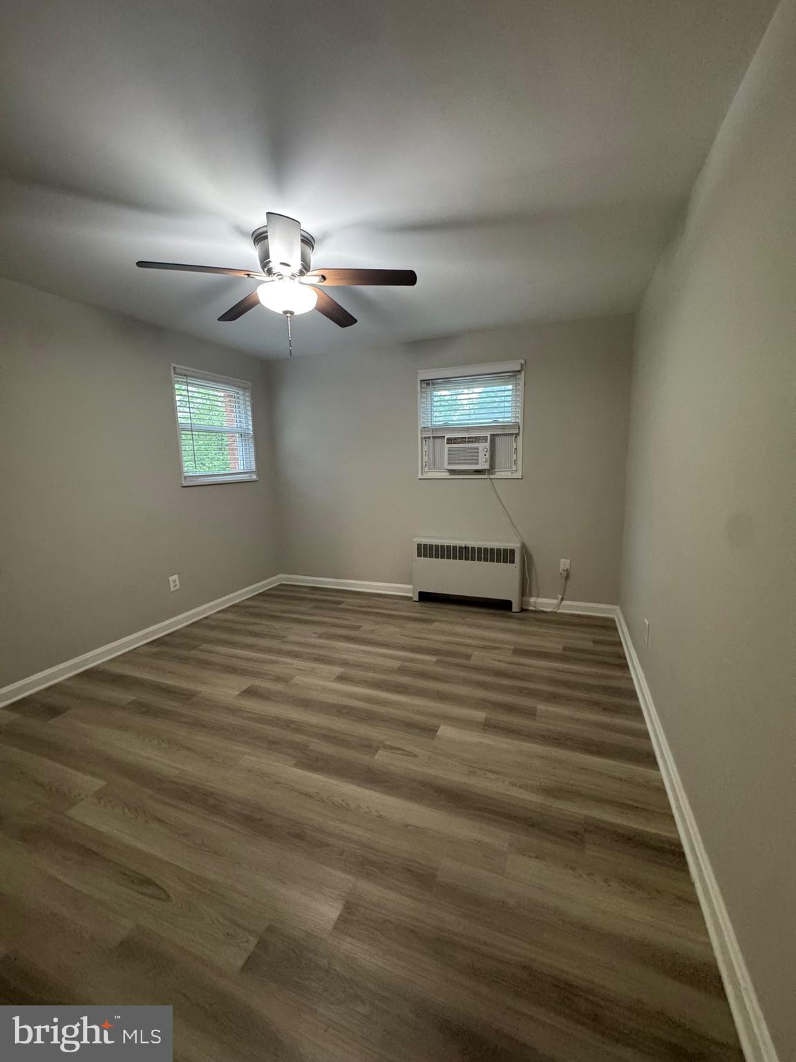 500 South Courthouse Road, Unit 5 Arlington, VA 22204 - Photo 15 of 16 a view of a room with wooden floor and a ceiling fan