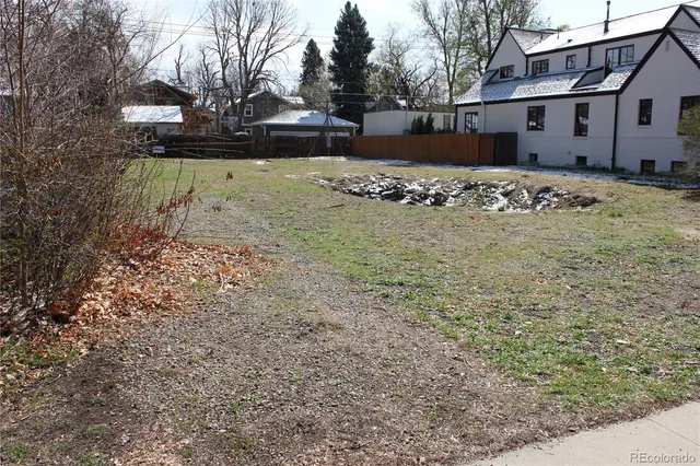 a view of a house with snow on the side of the road