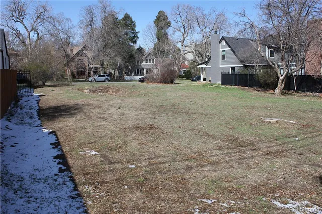 a view of a yard with a house and a tree