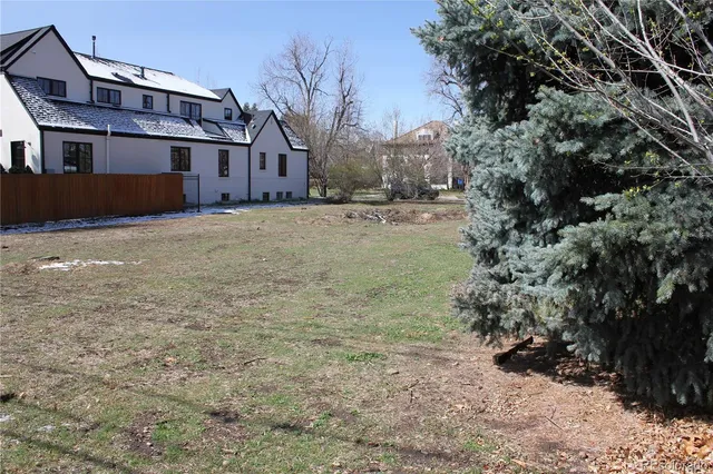 a view of large house with a yard covered in snow