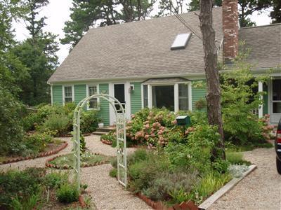 1685 Bridge Road Eastham, MA 02642 - Photo 1 of 22 a view of a house with brick walls and a tree