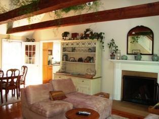 1685 Bridge Road Eastham, MA 02642 - Photo 12 of 22 a living room with furniture a fireplace and wooden floor