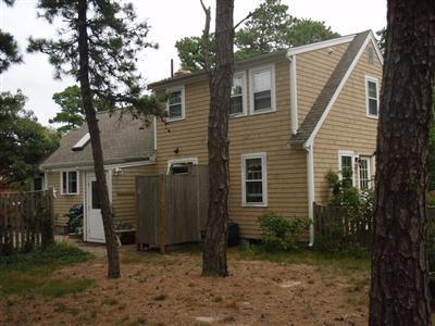 1685 Bridge Road Eastham, MA 02642 - Photo 7 of 22 a view of a house with a yard and wooden fence