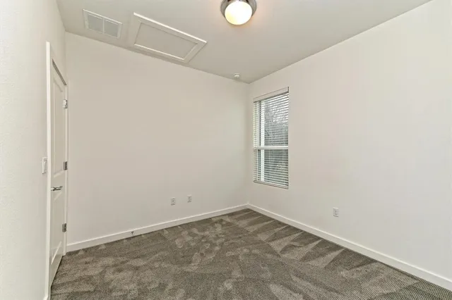 a view of a room that has a bed in it