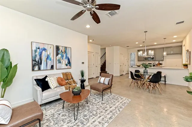 a living room with furniture and kitchen view