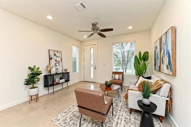 a living room with furniture a chandelier and a rug