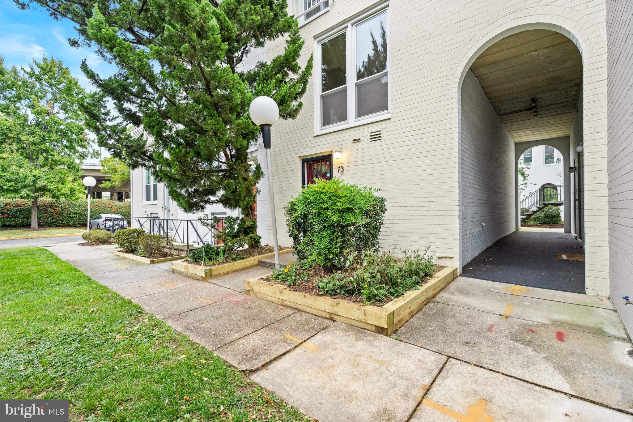 73 G Street Southwest, Unit 103 Washington, DC 20024 - Photo 2 of 35 a front view of a house with garden