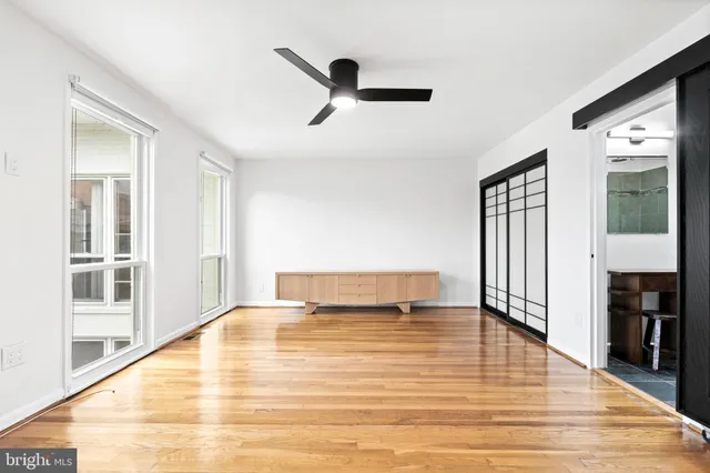 wooden floor in an empty room with a window