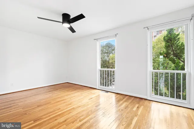 a view of a room with wooden floor and a window
