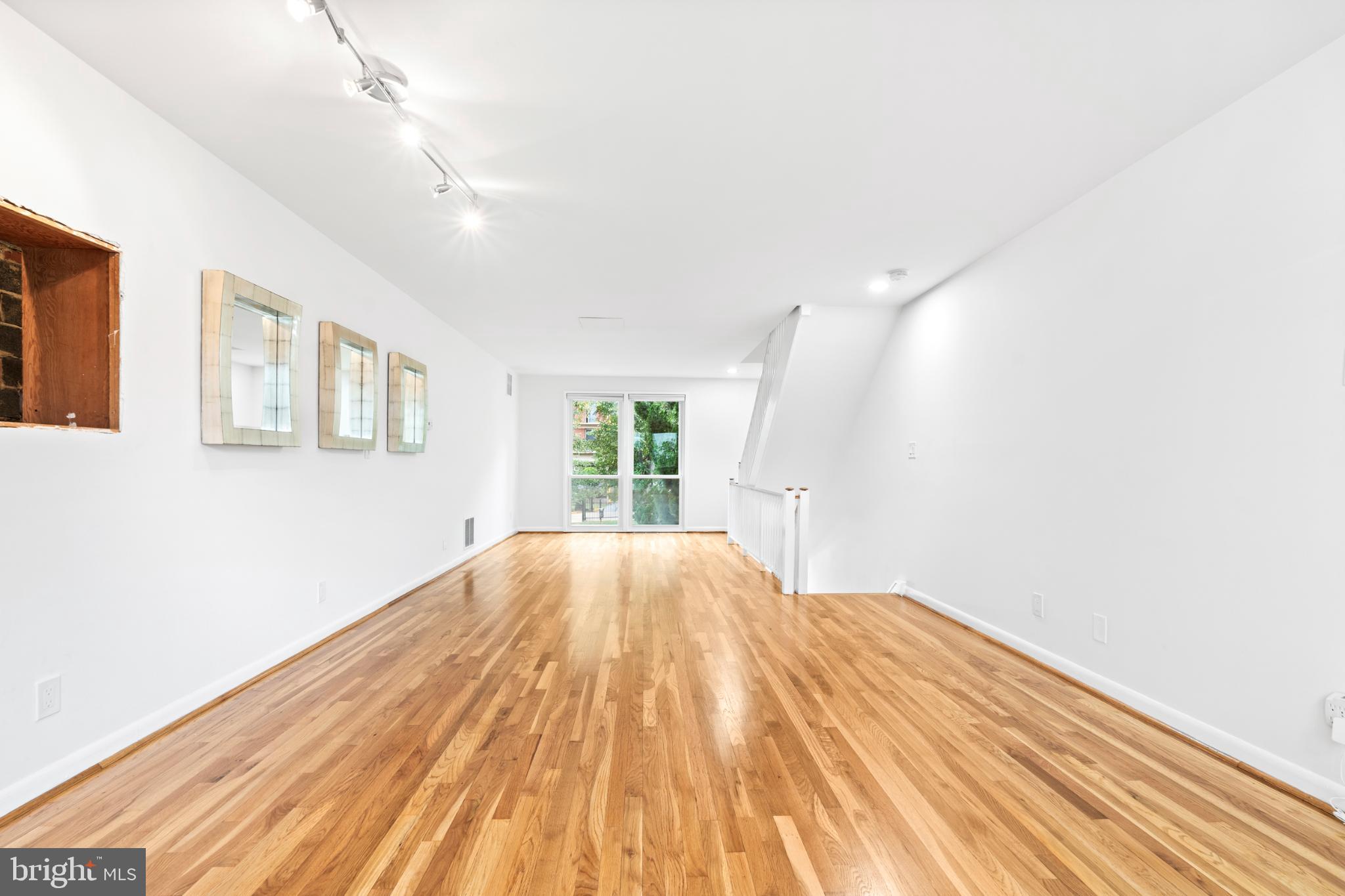 73 G Street Southwest, Unit 103 Washington, DC 20024 - Photo 29 of 35 a view of empty room with wooden floor and fan