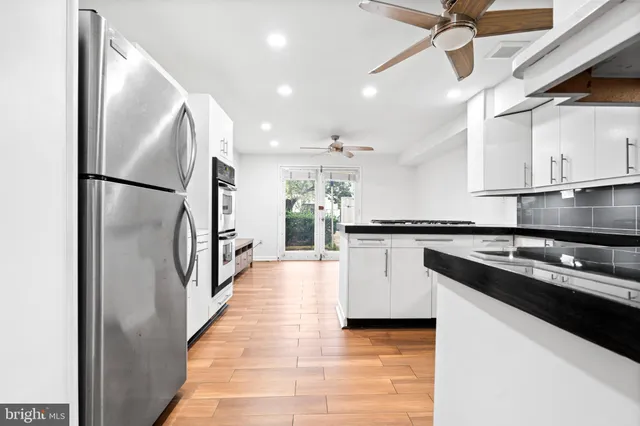 a view of a hallway with white walls and railing