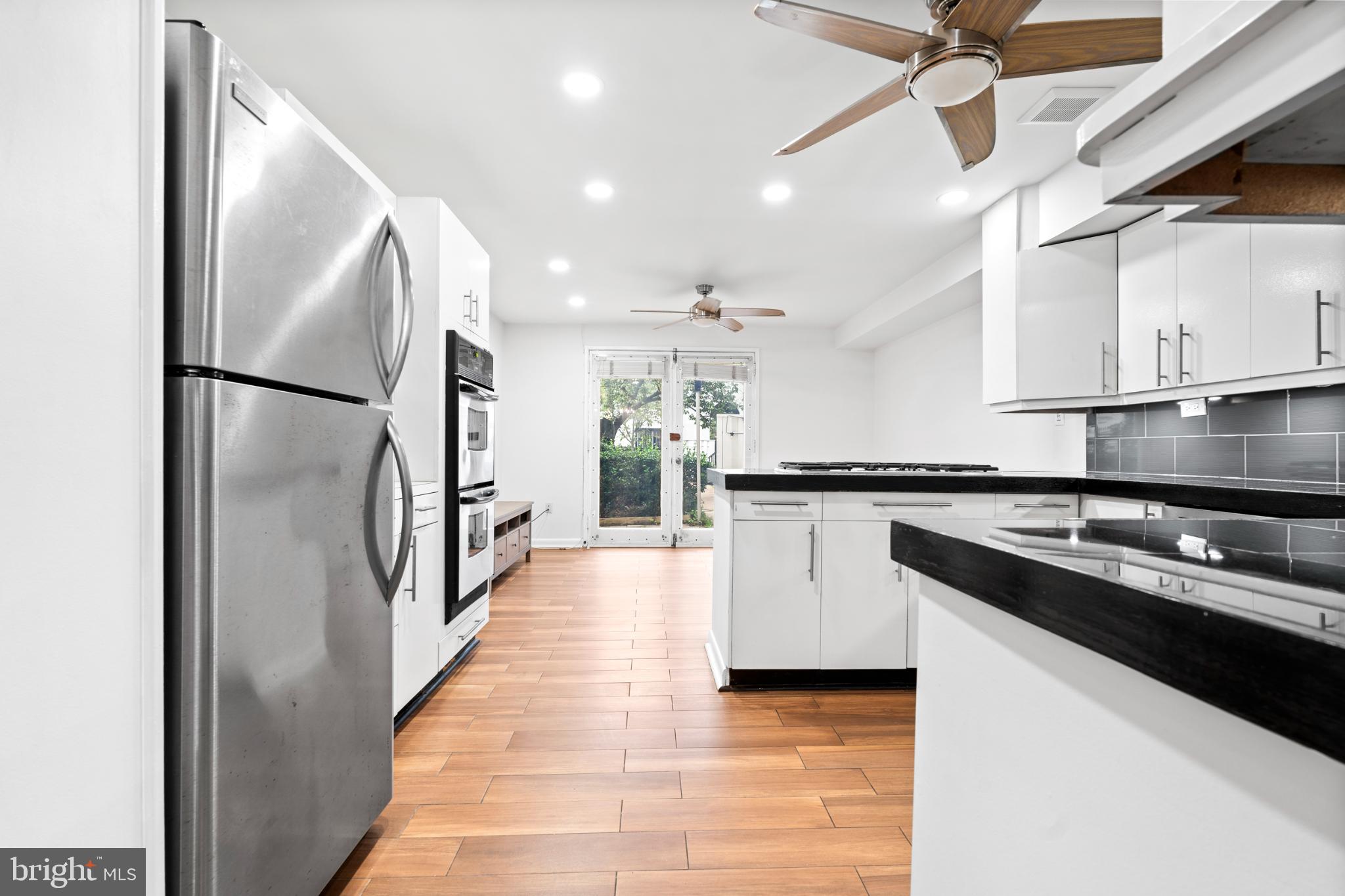 73 G Street Southwest, Unit 103 Washington, DC 20024 - Photo 4 of 35 a kitchen with stainless steel appliances granite countertop a refrigerator a sink and a stove