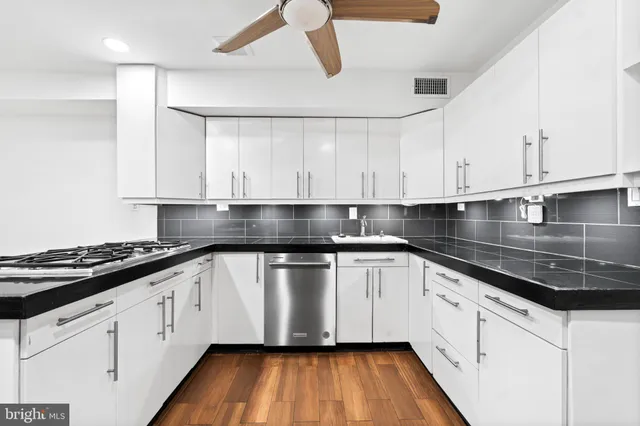 a kitchen with stainless steel appliances granite countertop a refrigerator a sink and a stove