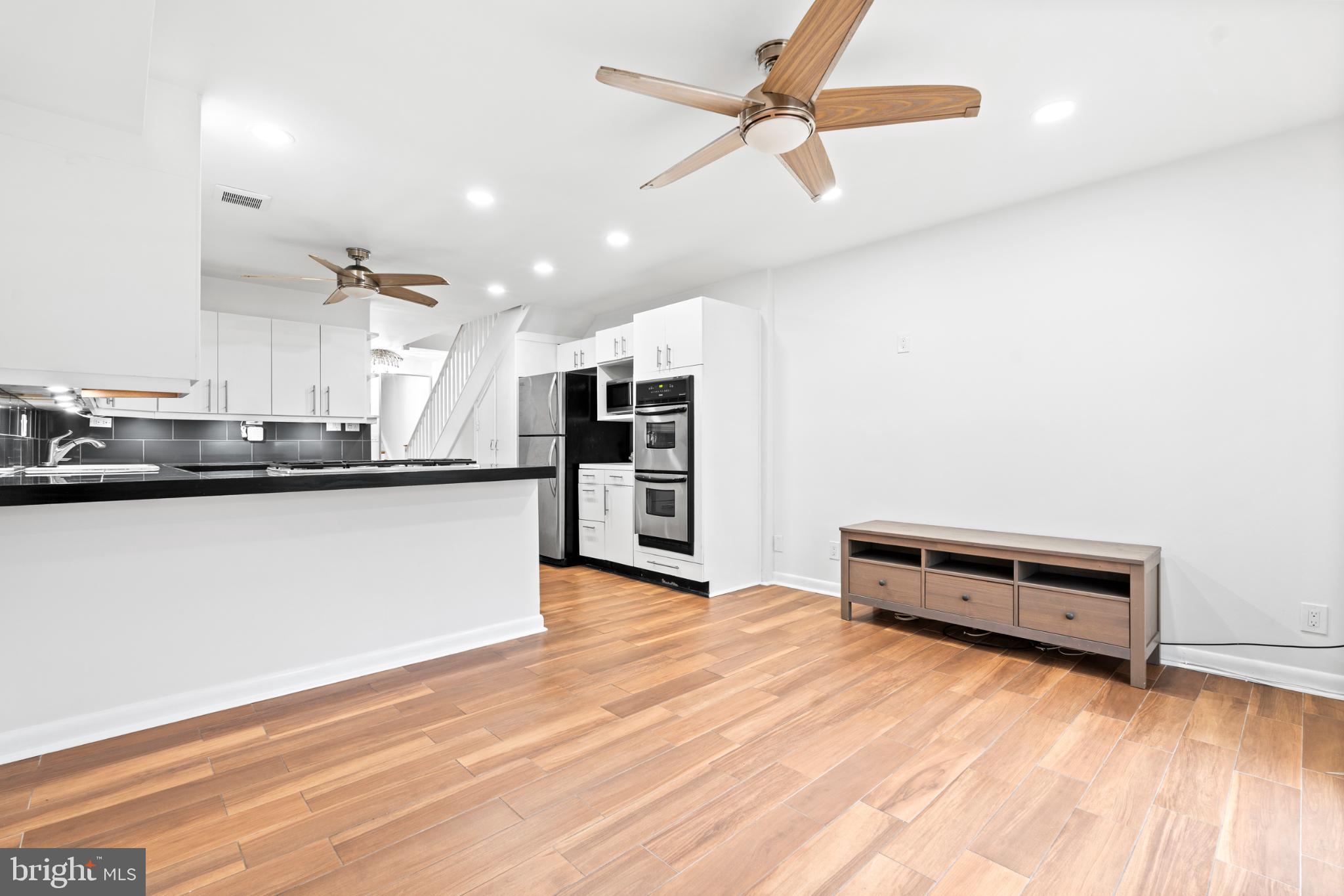 73 G Street Southwest, Unit 103 Washington, DC 20024 - Photo 8 of 35 a view of kitchen and hall with wooden floor