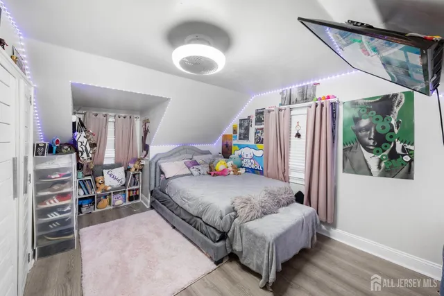 a bedroom with furniture and a wooden floor