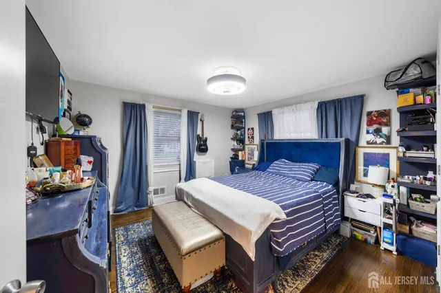 a bedroom with a bed and a book shelf