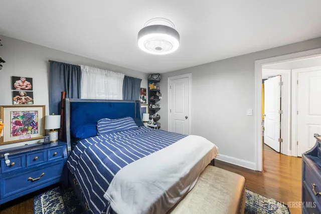 a bedroom with a bed and a painting on the wall