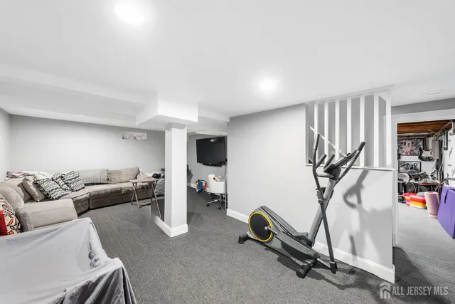 a living room with furniture a air conditioner and a window