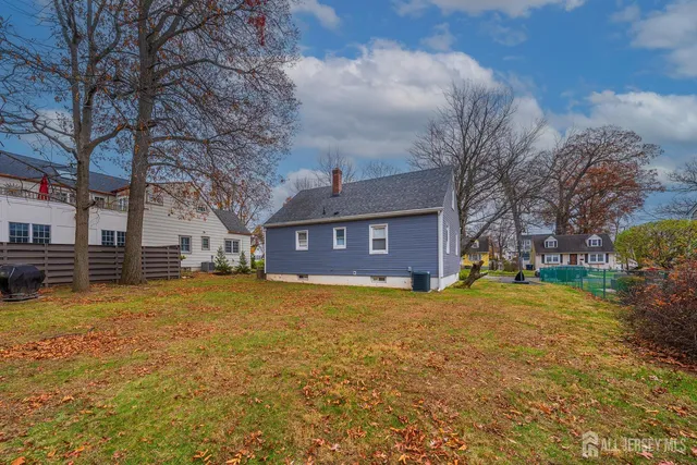 a view of a house with a yard covered with snow in the background