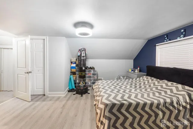 a bedroom with a bed and a closet